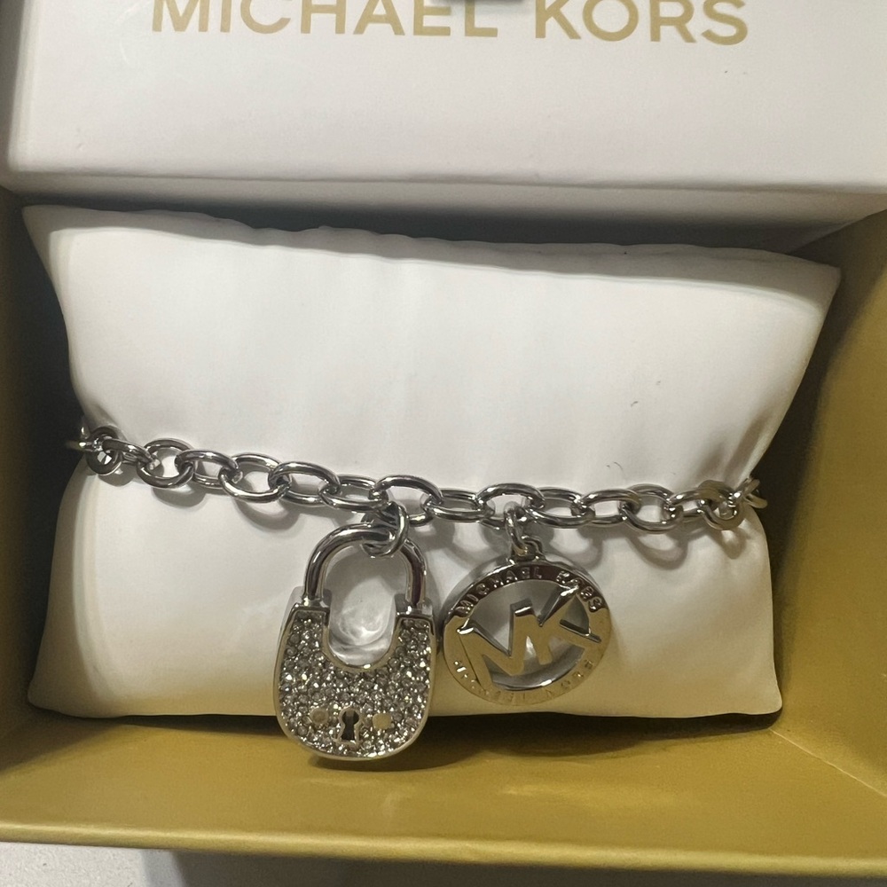 Michael Kors NWT Lock and Signature Logo Charm Bracelet comes in box with papers